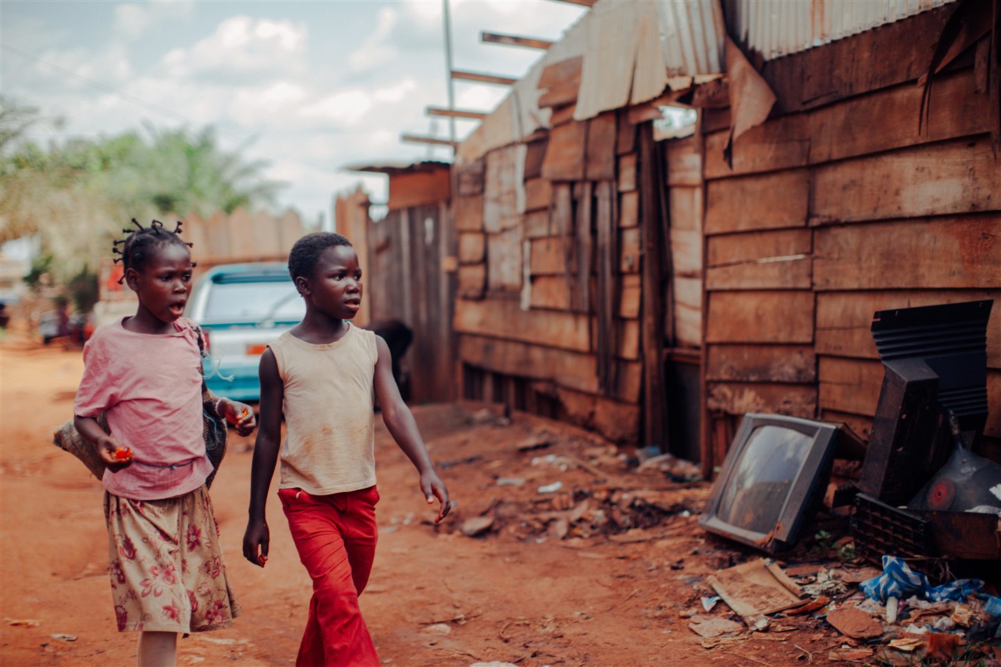 Children standing outside mud-brick homes in an available photograph
