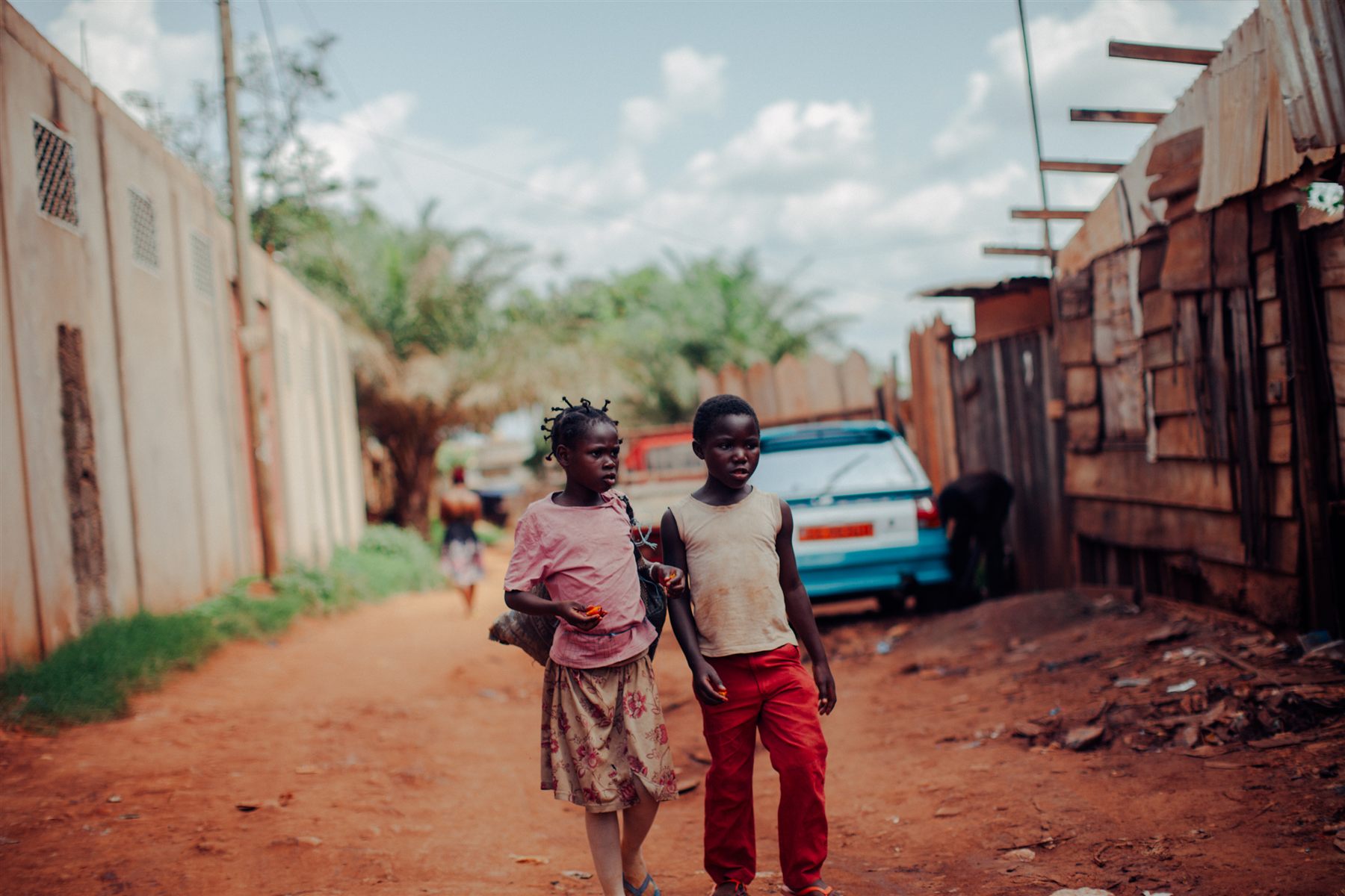 Two children walking along a road